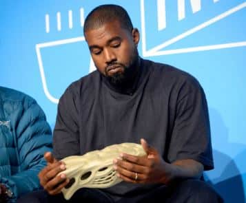 Kanye holding Yeezy sneakers - Fortune Kanye West