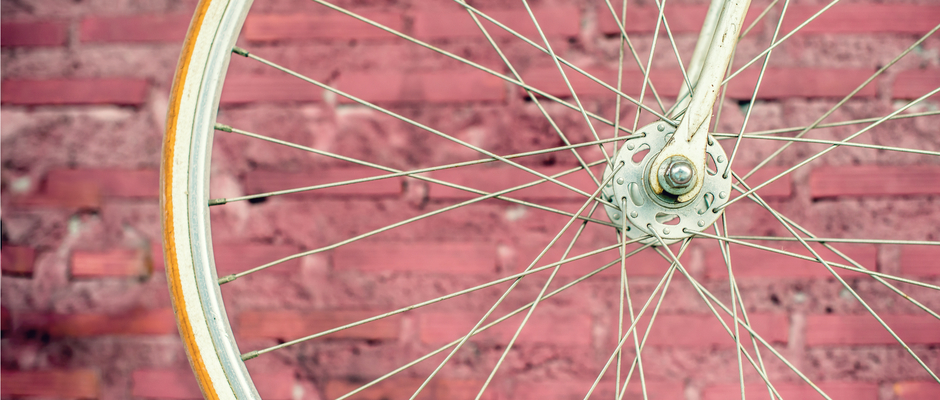 bicycle wheel with hub and spokes against brick wall