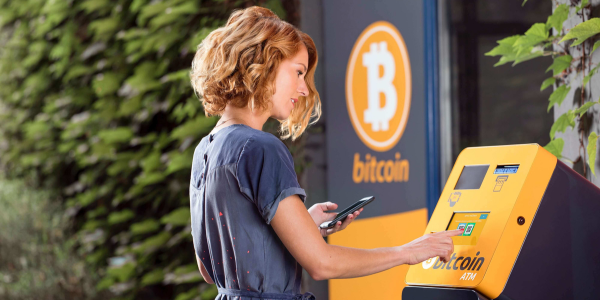 A woman using a Bitcoin ATM.