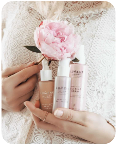 A micro-influencer's Instagram post for Lumene. The influencer is holding three Lumene products and a pink flower