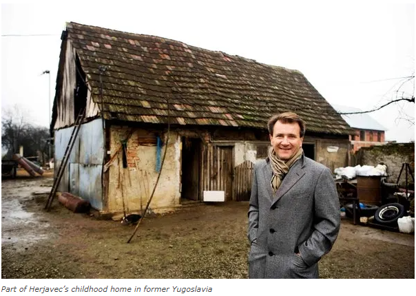 Robert Herjavec next to a small house in Croatia