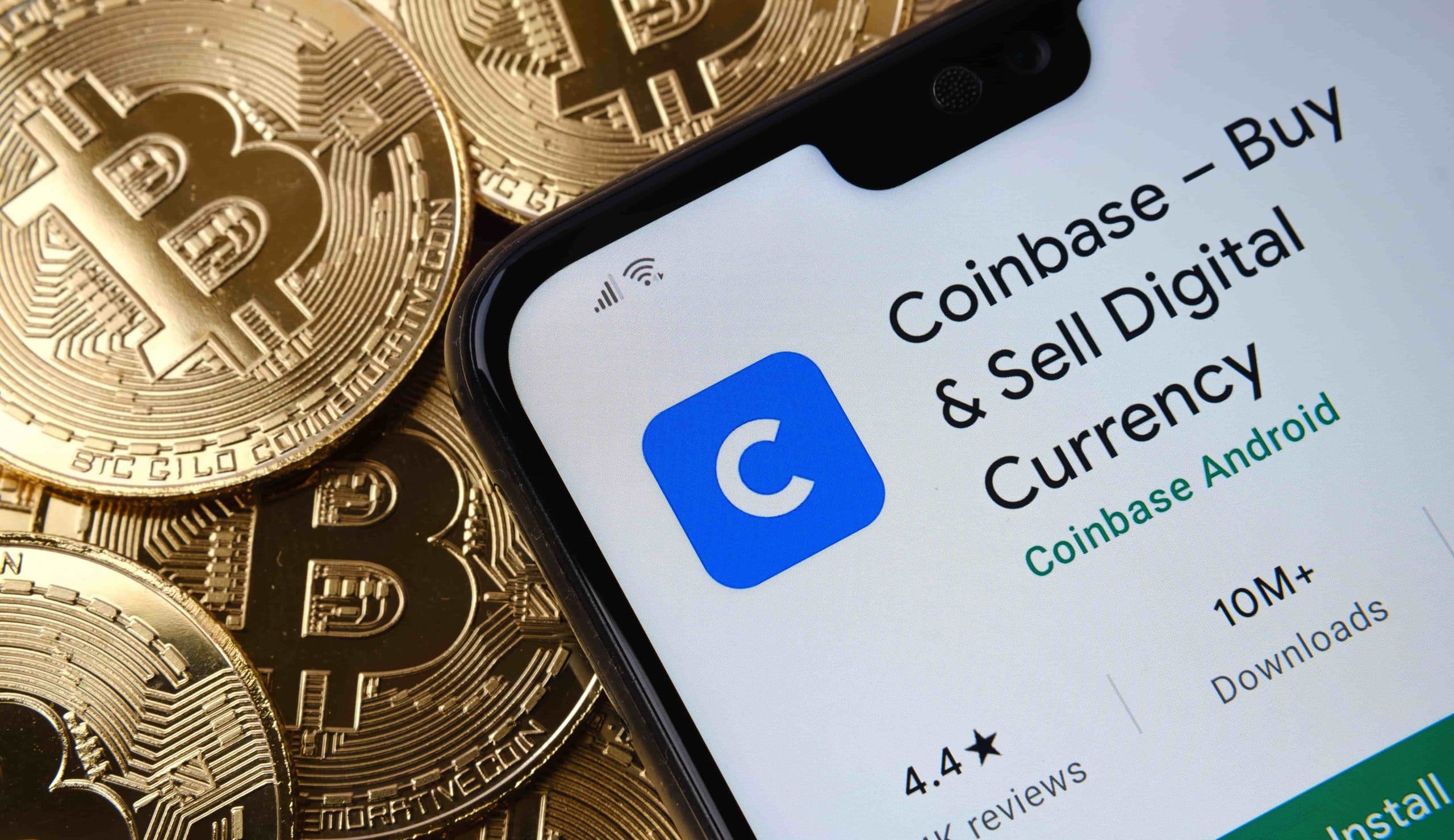 coinbase app store page next to bitcoin coins