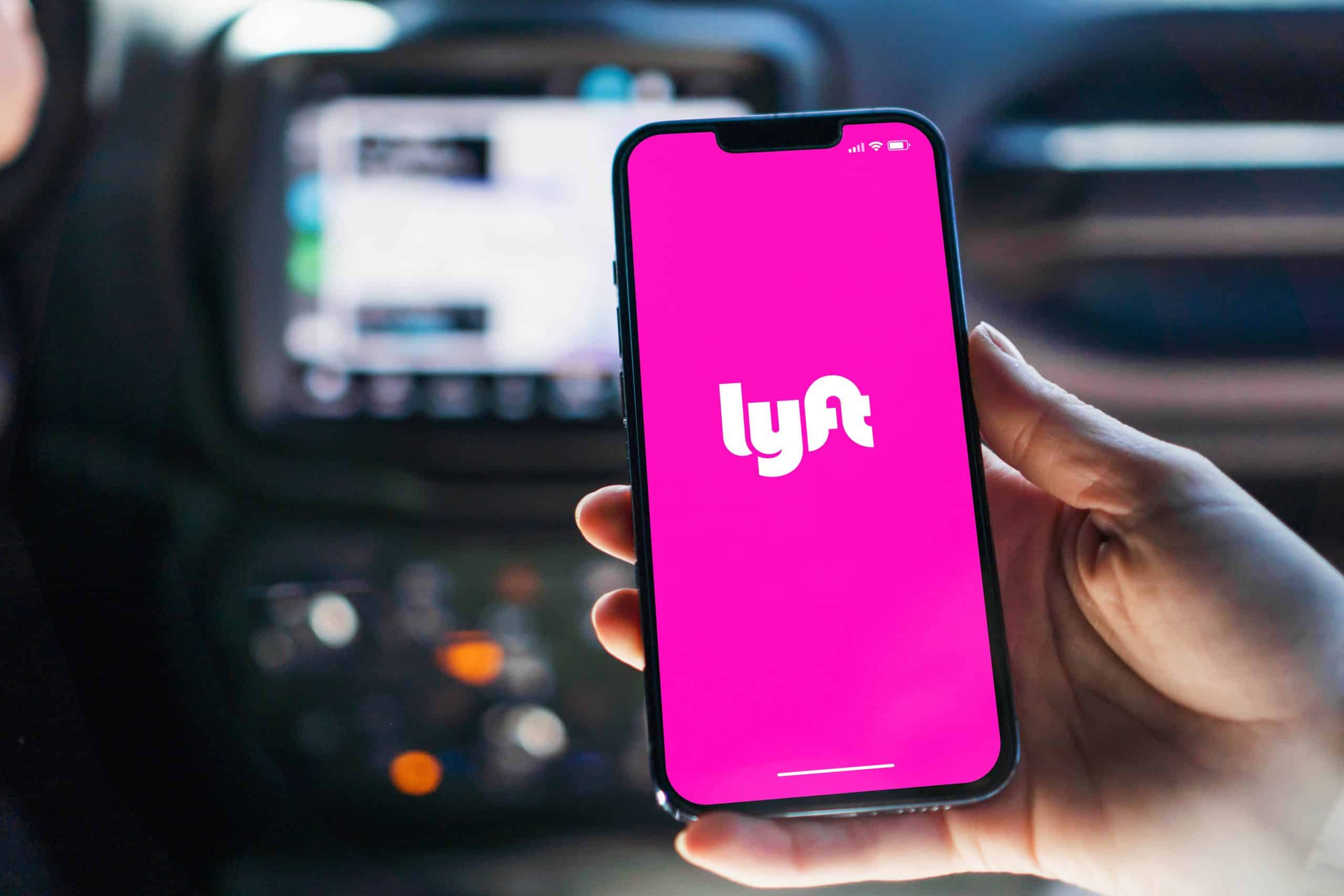 lyft logo on a phone in a car