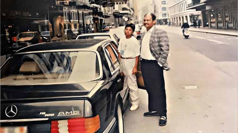 Anil Agarwal next to a car and another man