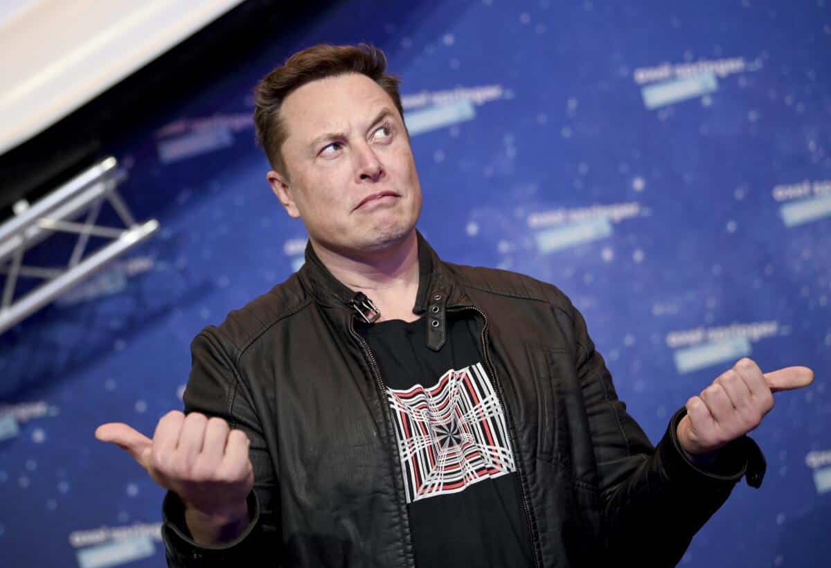 elon musk making a face and thumb gestures