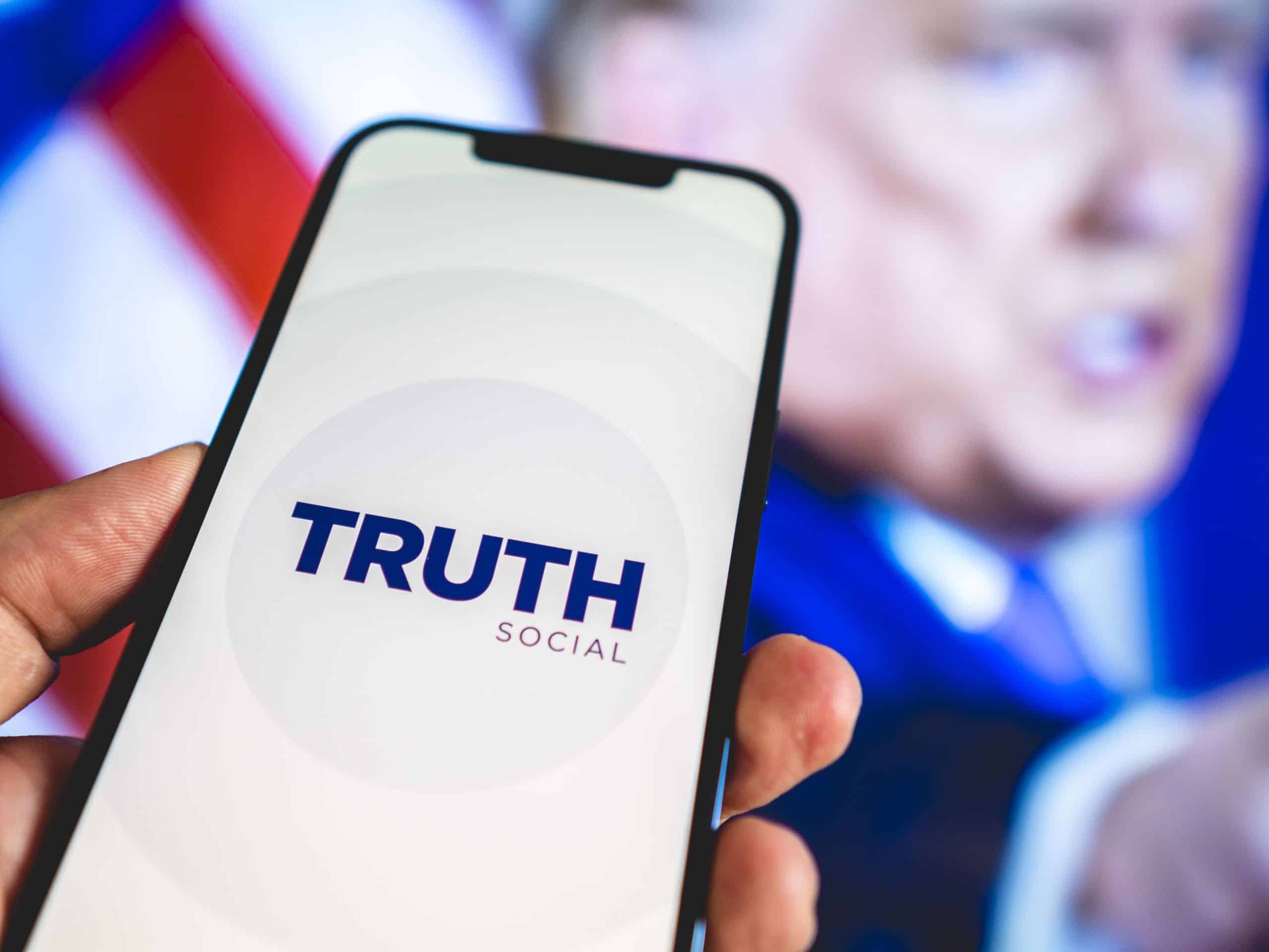 truth social on a phone in front of trump