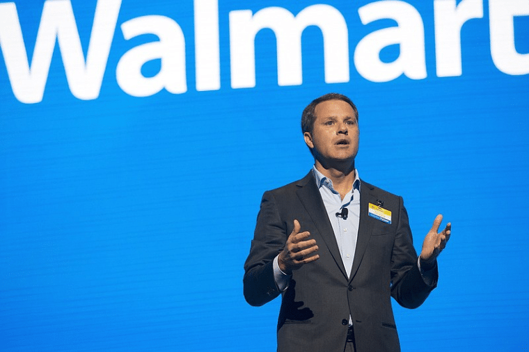 Doug McMillon speaking with Walmart logo in background