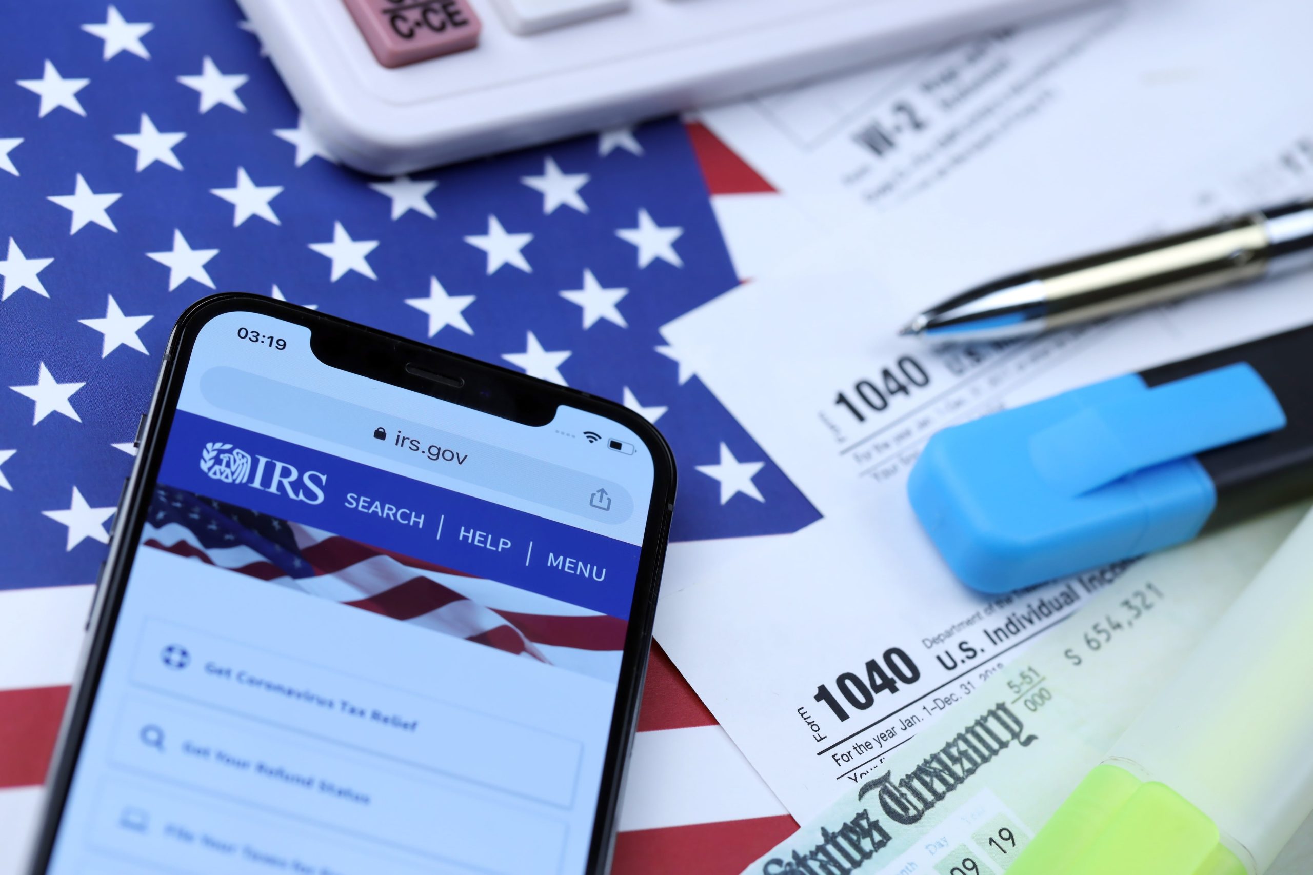 IRS on phone with flag in background