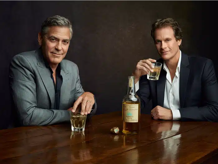 George Clooney drinking alcohol with another man