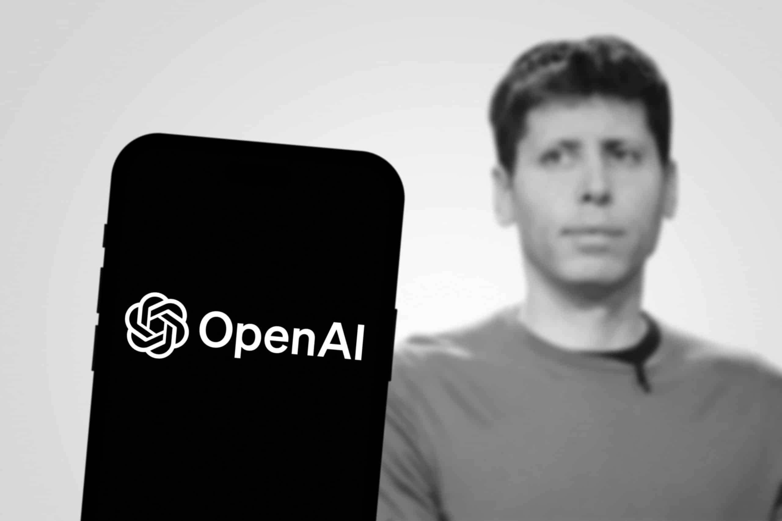 OpenAI on a phone in front of sam altman