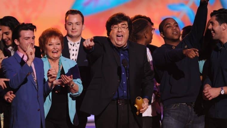 Dan Schneider accepting award on stage with colleagues