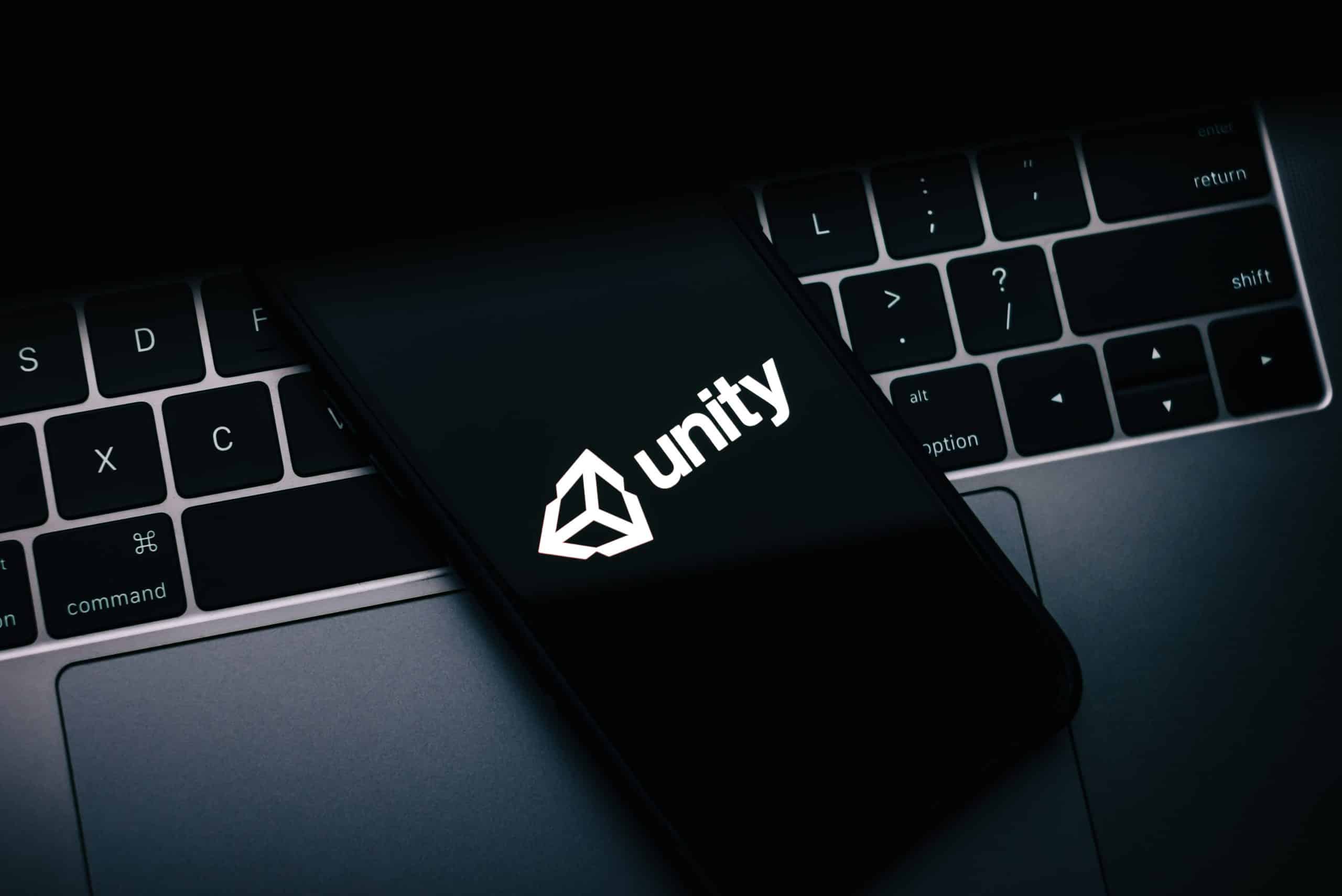 Unity logo on a phone screen on a laptop keyboard